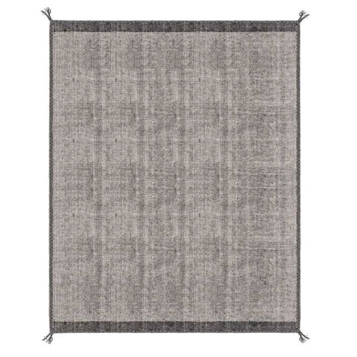 Tappeto Chathu grigio sotto tavolo da pranzo in ambiente luminoso

